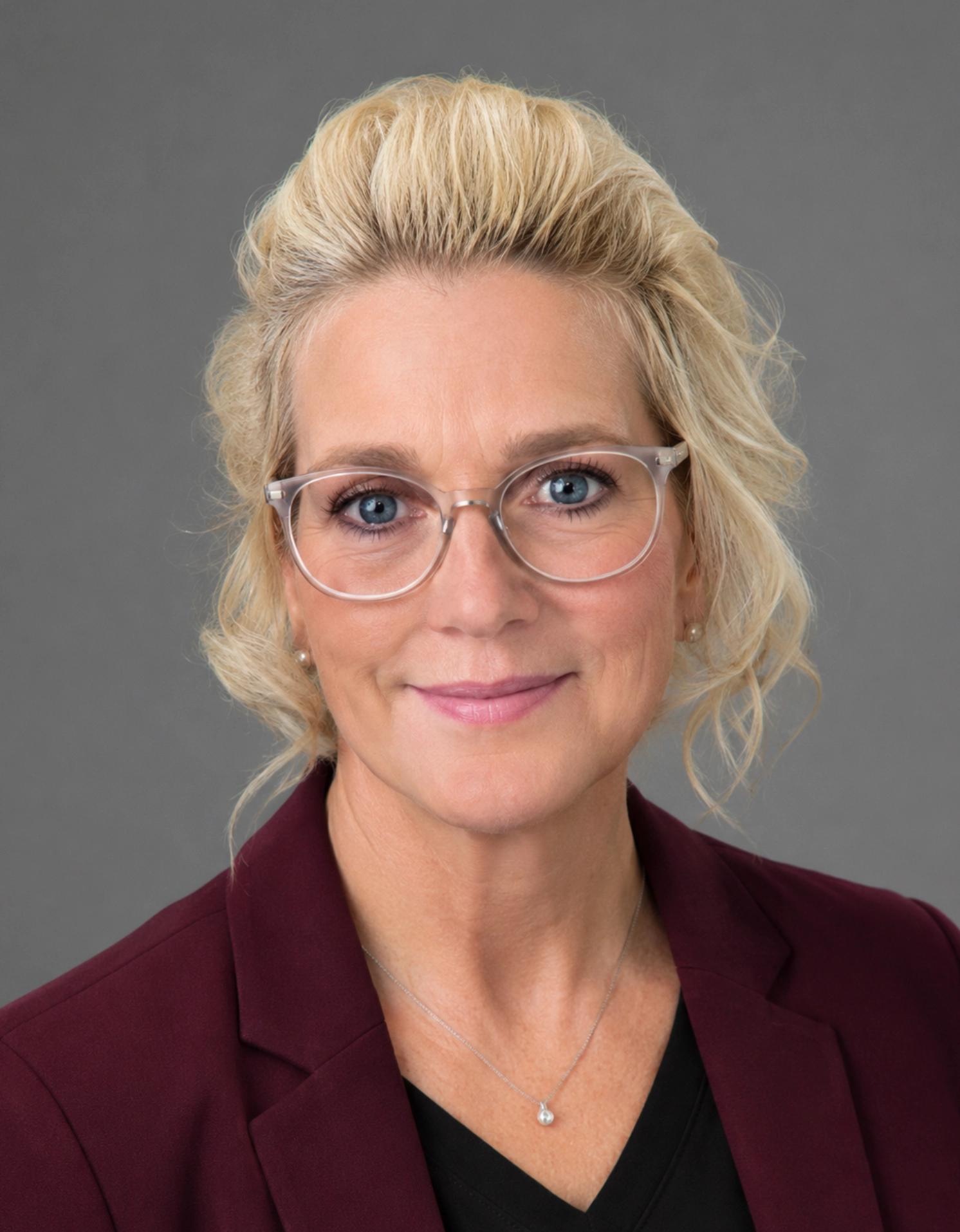 Woman with glasses and blonde hair